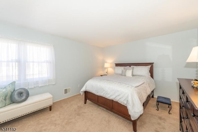 bedroom featuring light carpet and visible vents