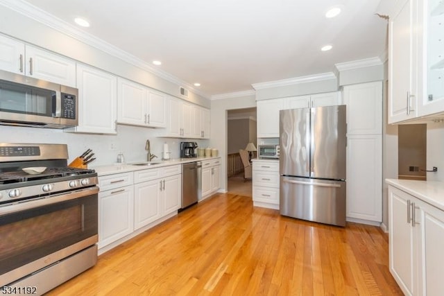 kitchen featuring white cabinetry, stainless steel appliances, and a sink