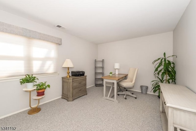 office space with baseboards, visible vents, and carpet flooring