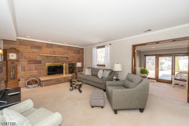 living area with crown molding, recessed lighting, visible vents, carpet flooring, and a stone fireplace