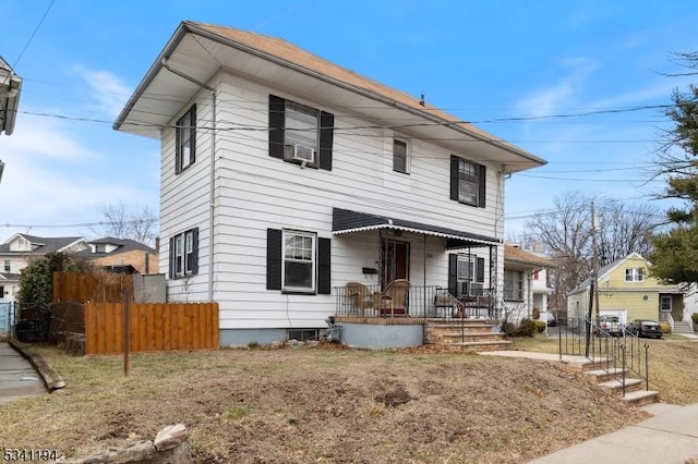 view of front of home featuring fence