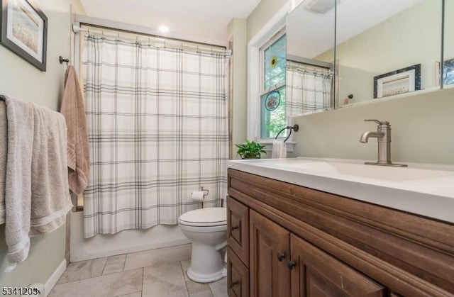 full bath with tile patterned flooring, vanity, toilet, and shower / bath combo with shower curtain