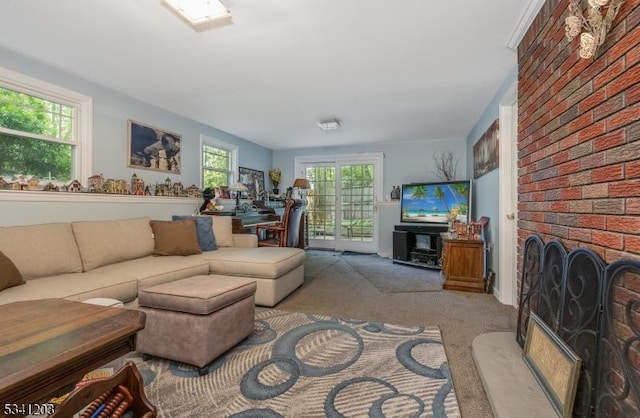 living area with carpet and a fireplace