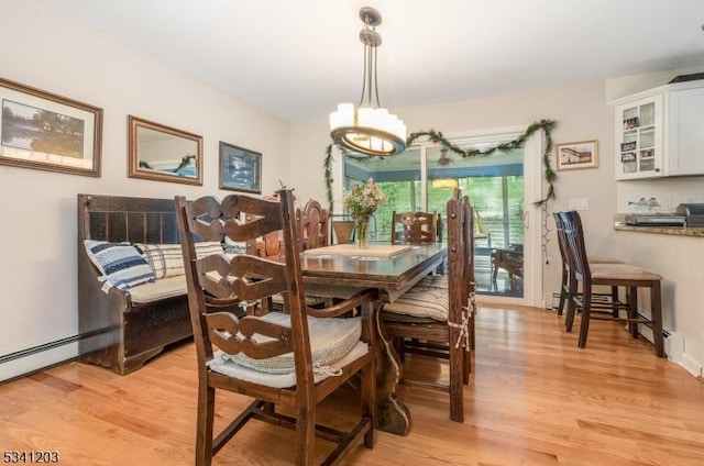 dining room with a chandelier and light wood-type flooring