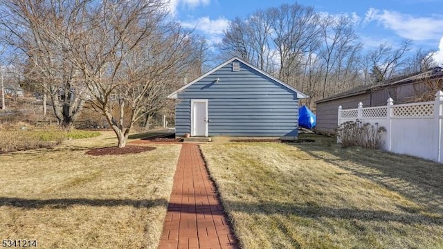 view of yard with fence and an outdoor structure