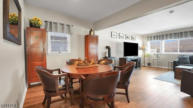 dining area with light wood-style floors and baseboards