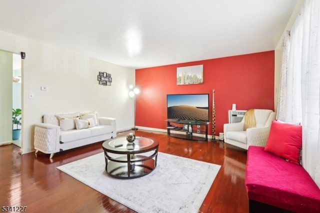 living area with wood finished floors and baseboards