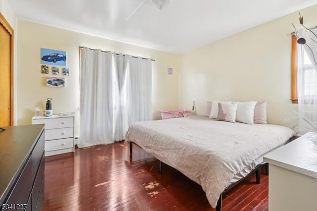 bedroom with dark wood finished floors