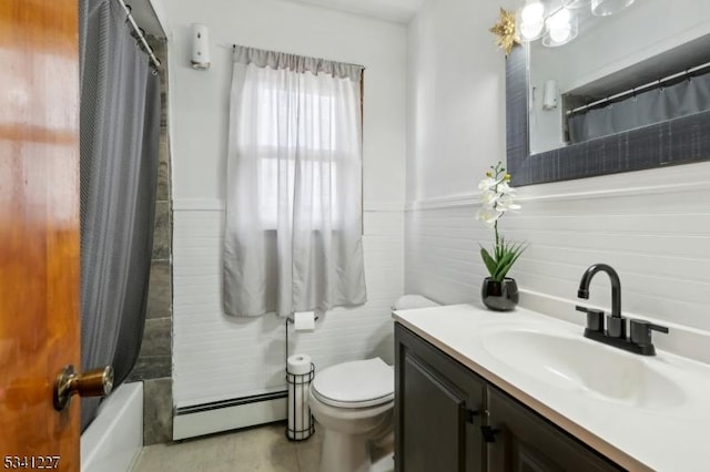 bathroom with a wainscoted wall, baseboard heating, vanity, and toilet