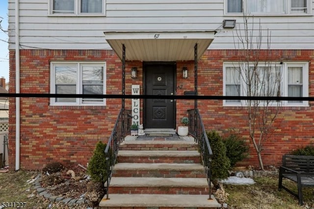 property entrance with brick siding