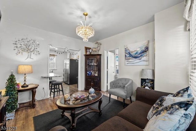 living area with an inviting chandelier and wood finished floors