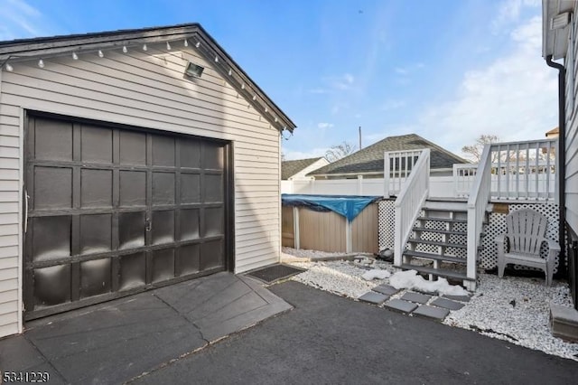 detached garage featuring fence