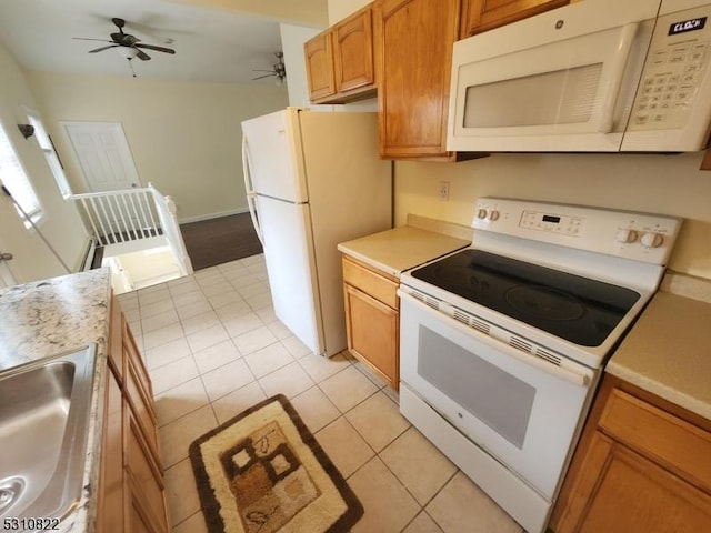 kitchen with light tile patterned flooring, white appliances, a sink, a ceiling fan, and light countertops