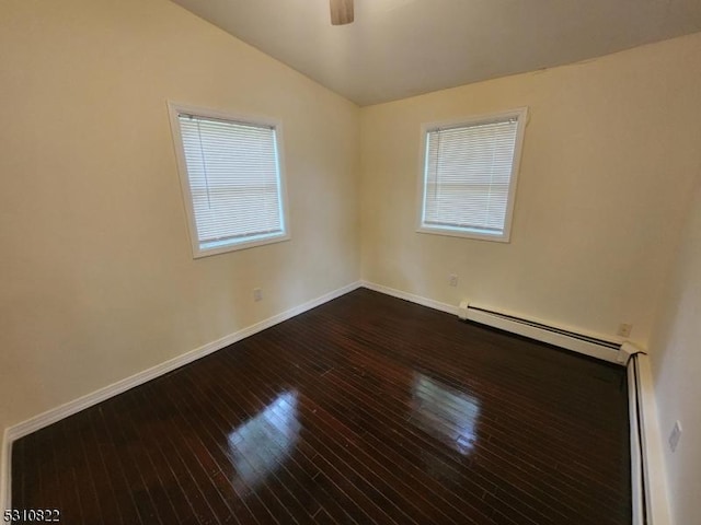 unfurnished room featuring dark wood-style floors, baseboard heating, vaulted ceiling, ceiling fan, and baseboards