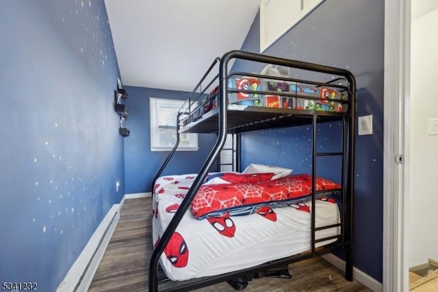 bedroom featuring wood finished floors and baseboards