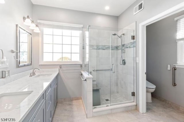 full bath featuring toilet, a stall shower, a sink, and visible vents