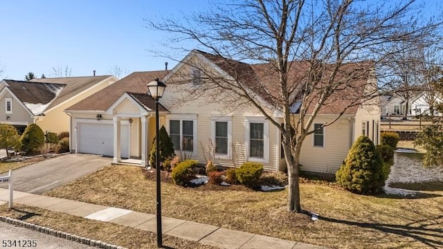 view of front of home featuring an attached garage and aphalt driveway