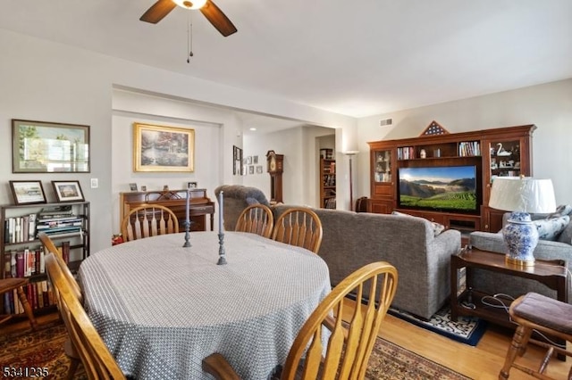 dining room with ceiling fan, wood finished floors, and visible vents