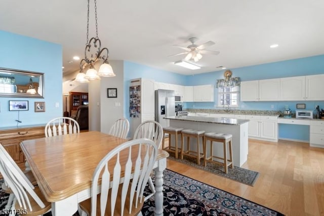 dining room featuring light wood-type flooring, ceiling fan, and recessed lighting