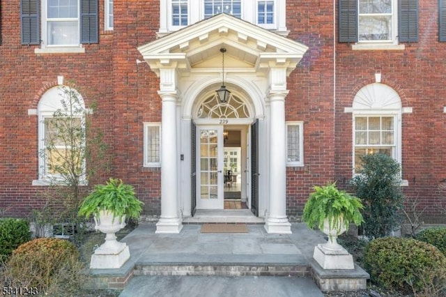 view of exterior entry with brick siding