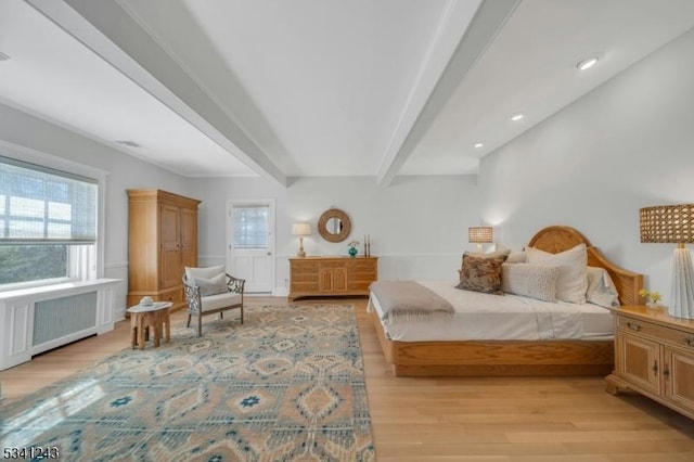 bedroom featuring beamed ceiling, radiator heating unit, light wood-style flooring, and recessed lighting