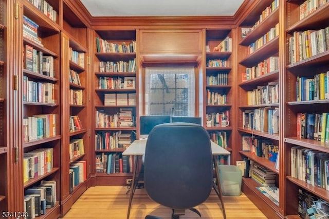 office area with bookshelves and light wood-style floors