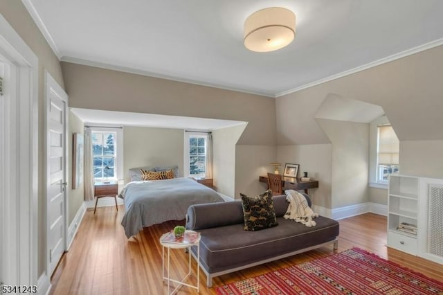 bedroom with crown molding, multiple windows, wood finished floors, and baseboards