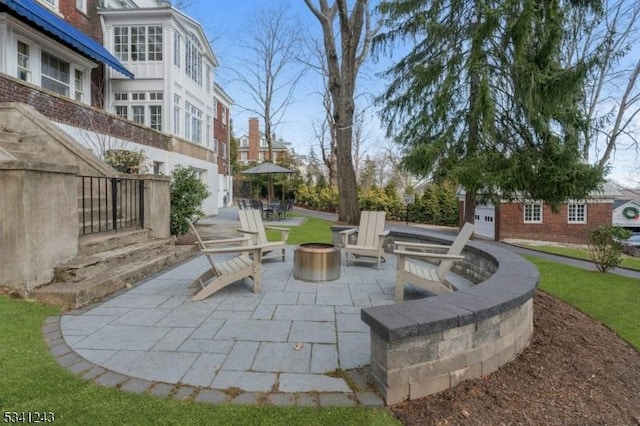 view of patio / terrace featuring an outdoor fire pit