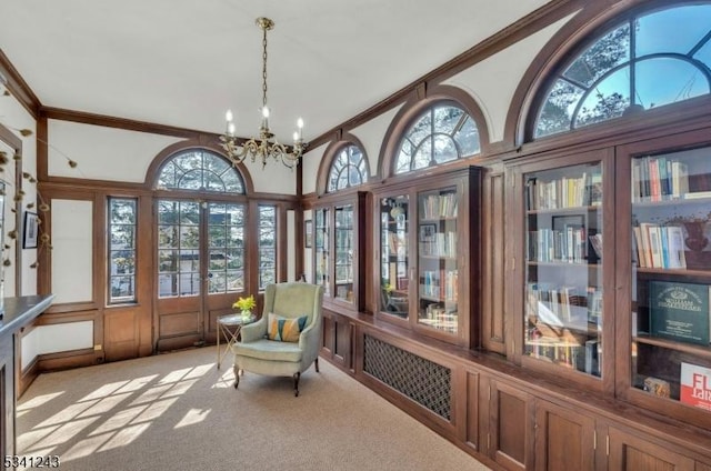 sunroom with a healthy amount of sunlight and a chandelier