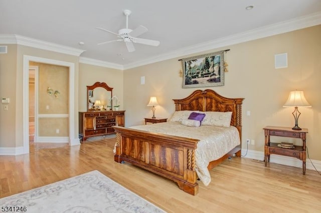 bedroom with light wood finished floors, visible vents, ornamental molding, a ceiling fan, and baseboards