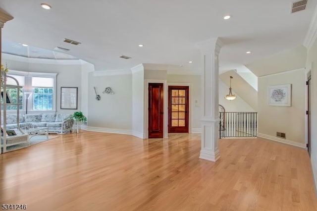 interior space with ornate columns, visible vents, and ornamental molding