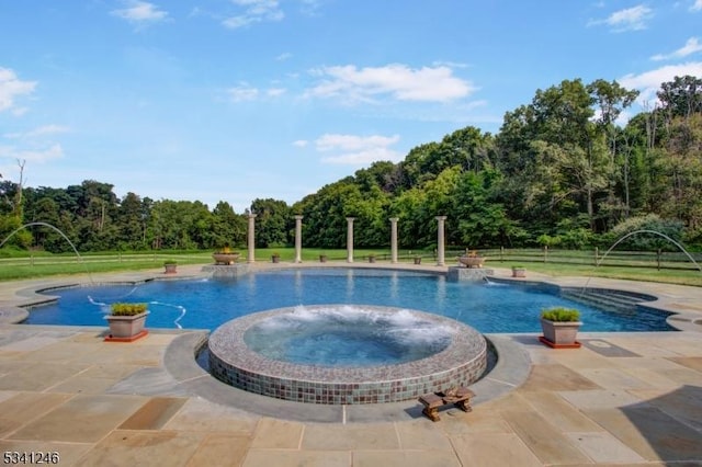 view of swimming pool featuring a pool with connected hot tub and a patio area