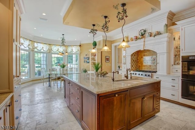 kitchen with dobule oven black, crown molding, stone tile floors, and a sink