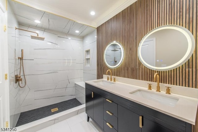 bathroom with a marble finish shower, recessed lighting, double vanity, and a sink