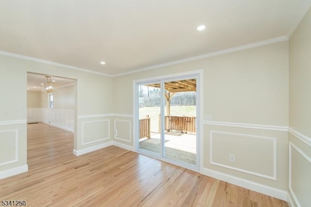 unfurnished room featuring light wood finished floors, recessed lighting, ornamental molding, wainscoting, and a decorative wall