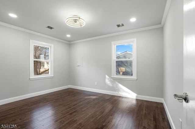 empty room with visible vents, baseboards, ornamental molding, dark wood-style flooring, and recessed lighting