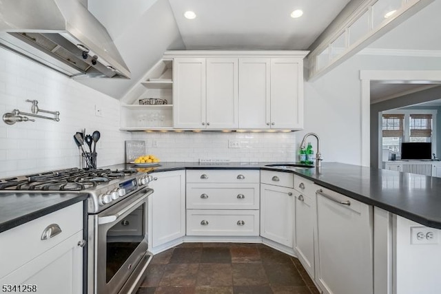 kitchen featuring ventilation hood, dark countertops, a sink, and gas range