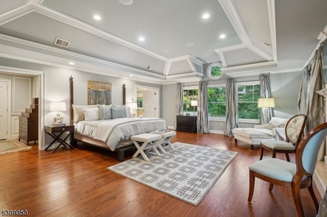 bedroom with ornamental molding, wood finished floors, and visible vents