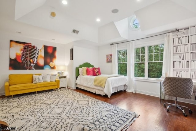 bedroom with baseboards, visible vents, wood finished floors, and recessed lighting