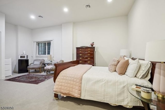 carpeted bedroom with visible vents and recessed lighting