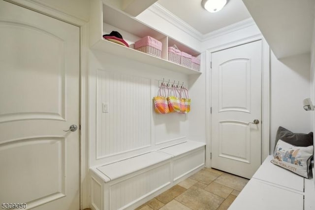 mudroom featuring crown molding and stone tile floors