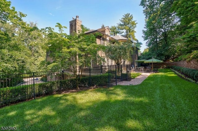 view of yard with fence and a patio