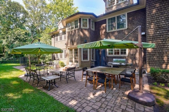 view of patio / terrace with entry steps, outdoor dining area, and area for grilling