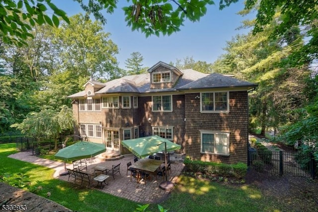 rear view of house featuring a yard, a patio area, and fence