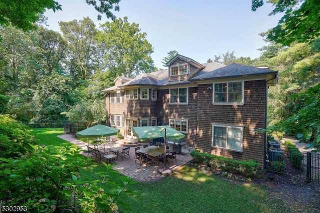 back of house with a yard, fence, and a patio