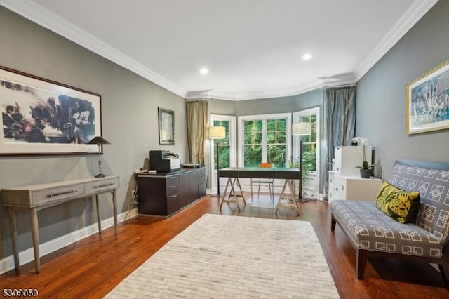 living area with ornamental molding, baseboards, and wood finished floors