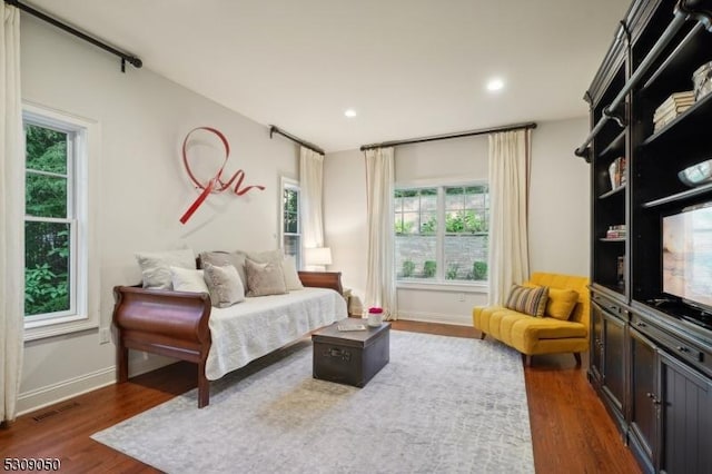 bedroom featuring visible vents, baseboards, dark wood-type flooring, and recessed lighting