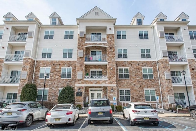 view of building exterior with uncovered parking