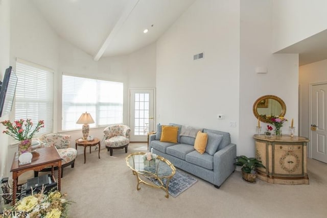 carpeted living area with high vaulted ceiling, visible vents, and beam ceiling