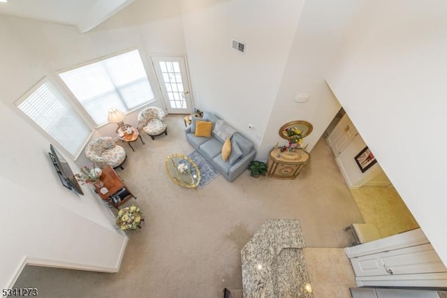 carpeted living area featuring visible vents